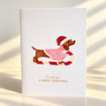 Carte de Noël Joyeux Woofmas – Teckel et dorure à chaud